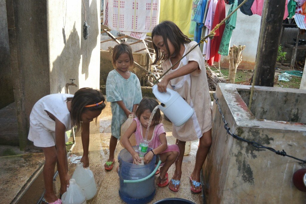 girls fetching water for their Moms who were in charge of cooking their food