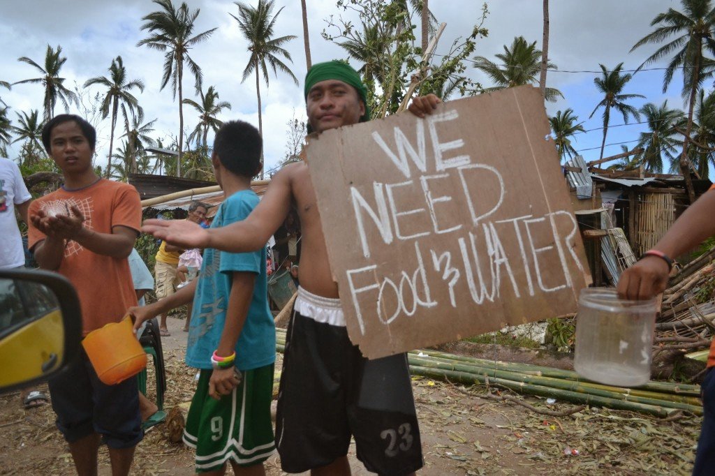 A man holding a cardboard saying that "they need food and water"