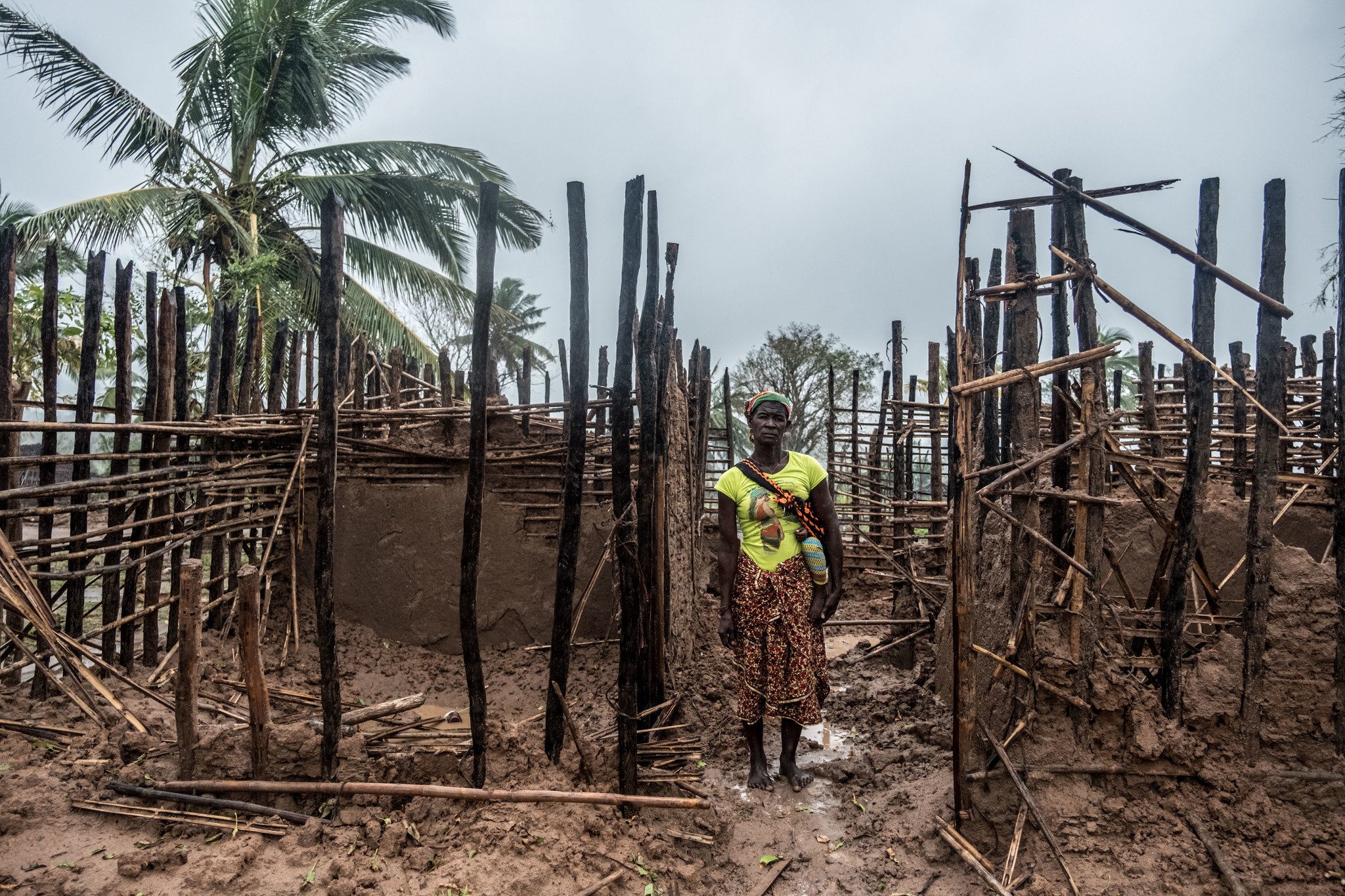 Mayasa stands in the ruins of her home in a village in northern Mozambique.