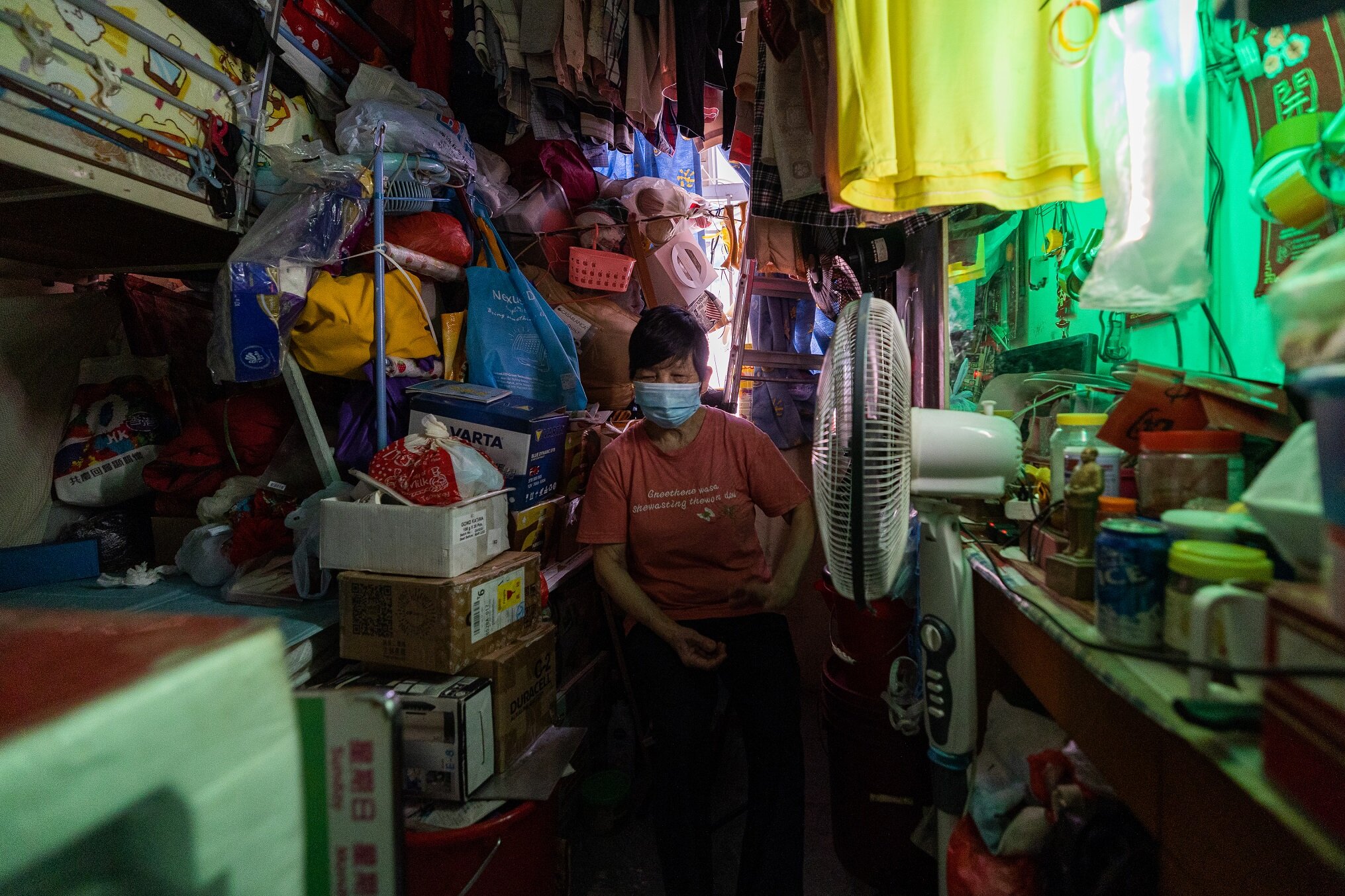 Woman sitting in cramped subdivided flat