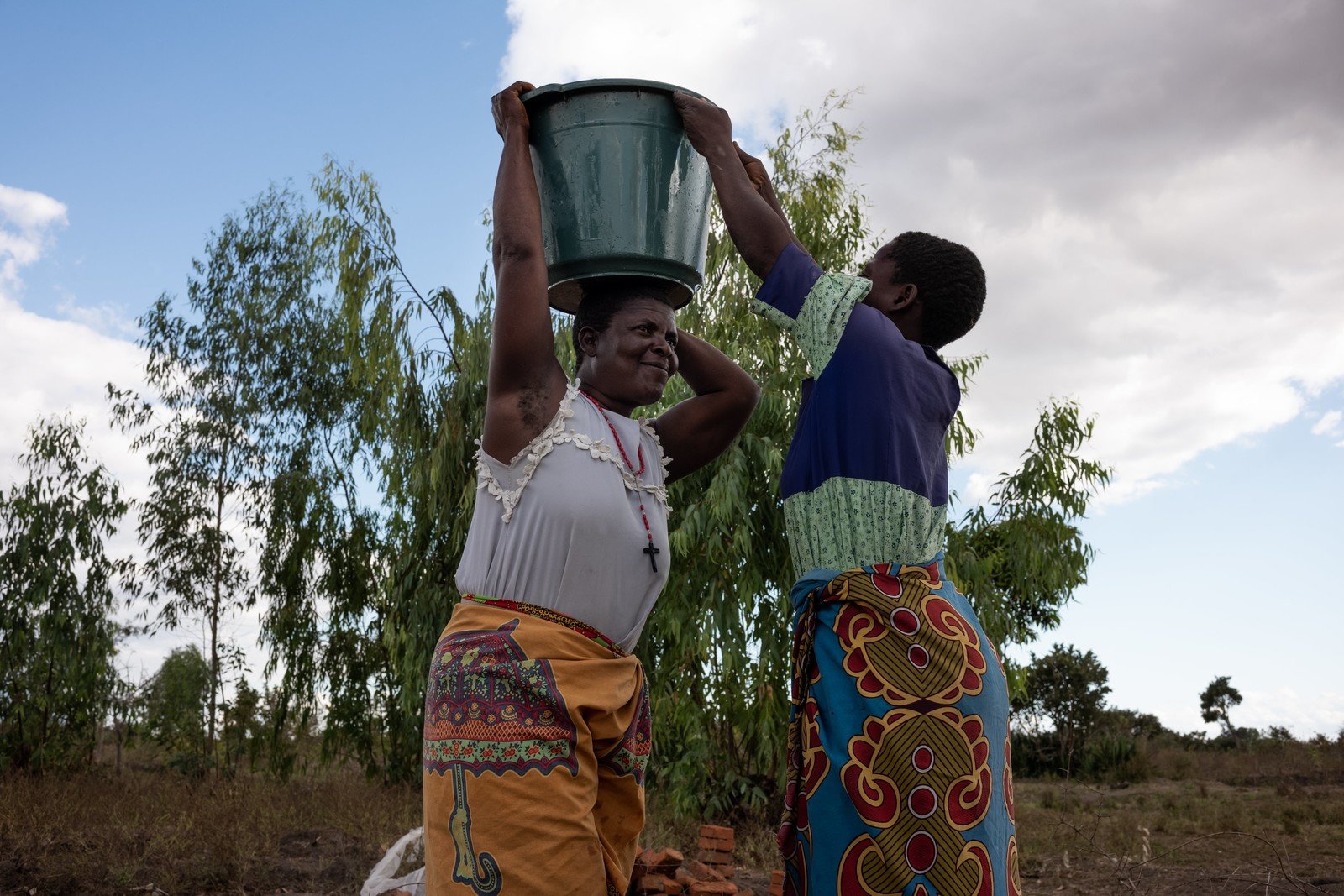 Mary Gawani (right), 32, and Mary Kamanga (left) , 51, collect water at a borehole constructed by Oxfam in Gwembere Village in Phalombe District in southern Malawi. (Photo: Ko Chung Ming / Oxfam Volunteer Photographer)