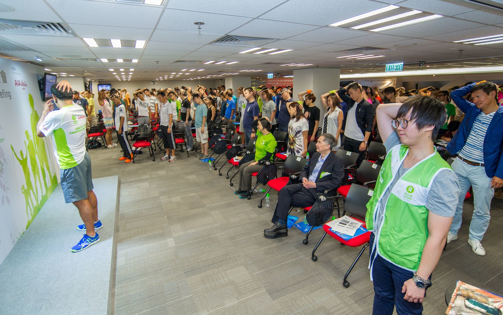 Over 300 walkers attended the Oxfam Trailwalker 2015 briefing and practiced warm-up exercises.