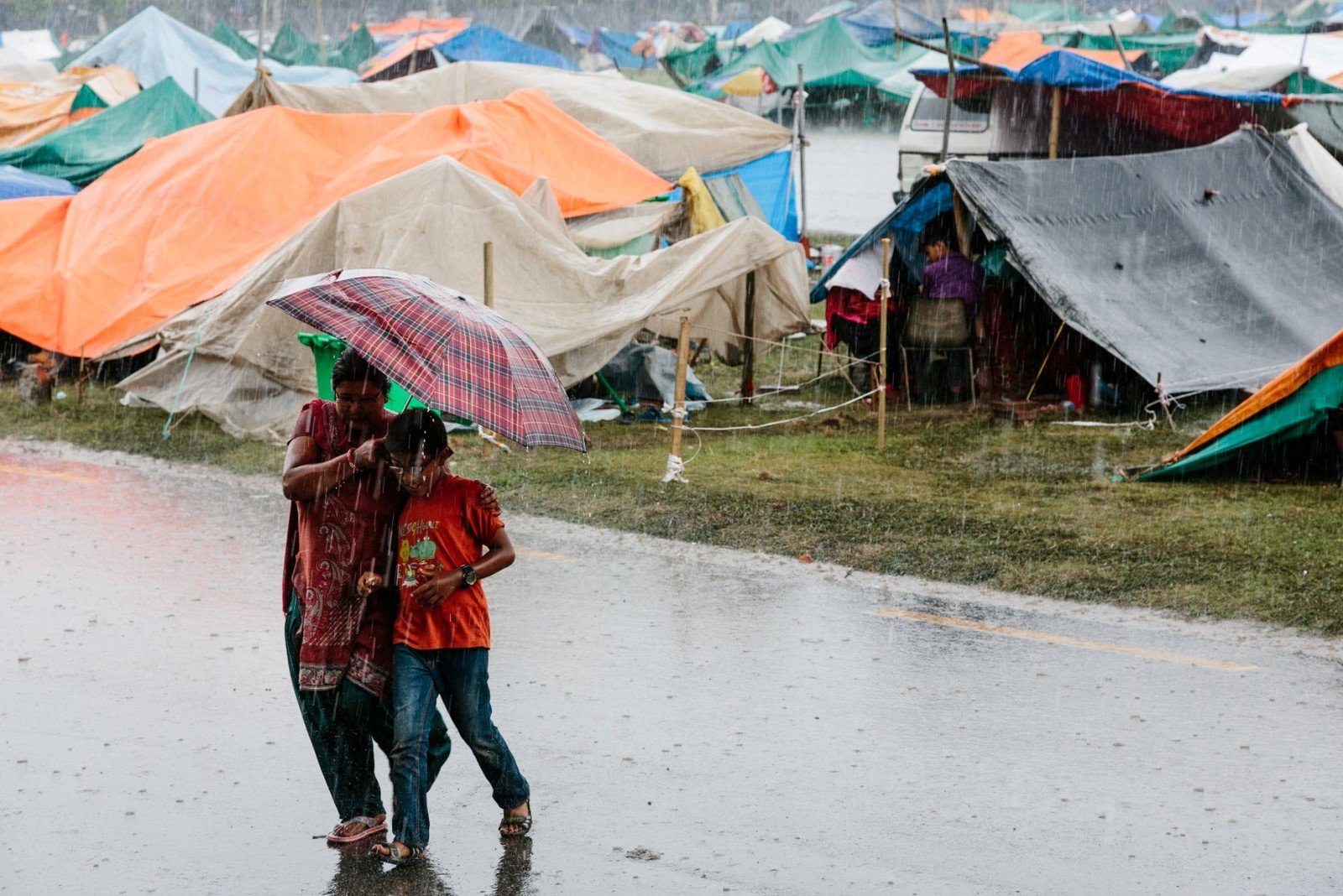 PR1：Worried about aftershocks, earthquake survivors were forced to sleep out in the open for days. Heavy rain has also made their situation more difficult. (Aubrey Wade / Oxfam)