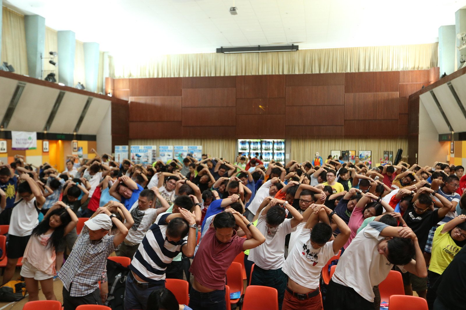 Over 300 walkers attended the Oxfam Trailwalker 2014 Briefing and they were practicing warm-up exercise.