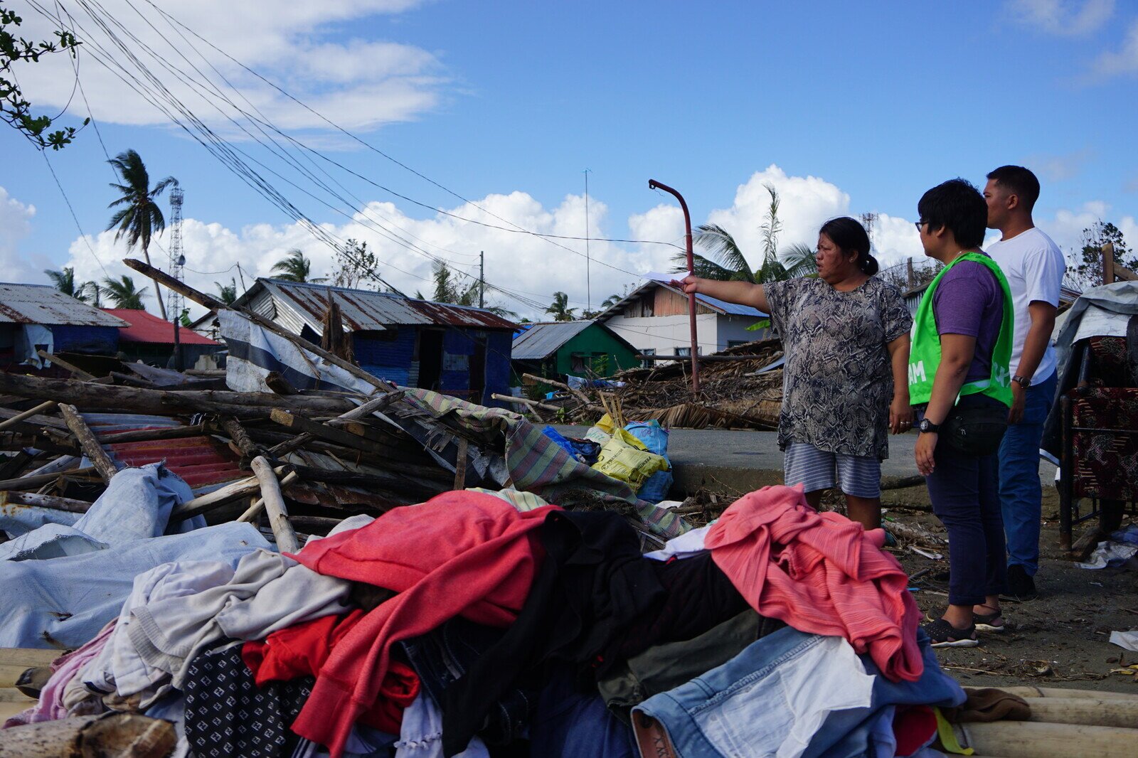 Cristy Espina showing what is left of her house in the aftermath of Typhoon Phanfone to humanitarian responders from Oxfam in the Philippines and its partner, the Philippine Rural Reconstruction Movement. (Photo: April Bulanadi / Oxfam)