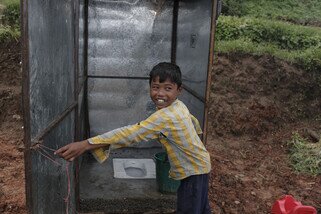 Deepak is happy to have access to a proper toilet, installed by Oxfam in the village of Burunchili. Having a clean toilet, soap and clean water for hand-washing, are crucial to prevent disease, particularly when many people live together after a disaster. (Photo: Sam Tarling/Oxfam)