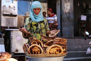 Marriam travels from Sabir Mount to the city centre to sell bread and earn an income. Most of the city’s bakeries have closed. Her grandchildren are reliant on her income after their parents died.