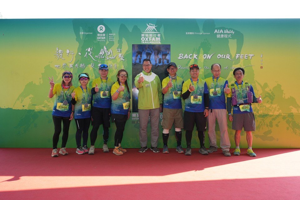 Michael Wong and the last teams to cross the finish line at Oxfam Trailwalker 2022. They completed the 100 km in 46 hours and 3 minutes.