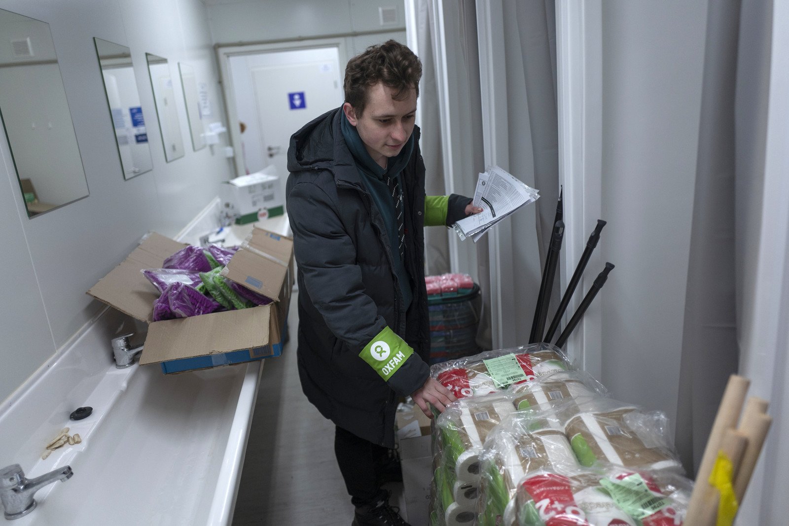 Oxfam staff arranges hygiene items for displaced people in Novoselivka