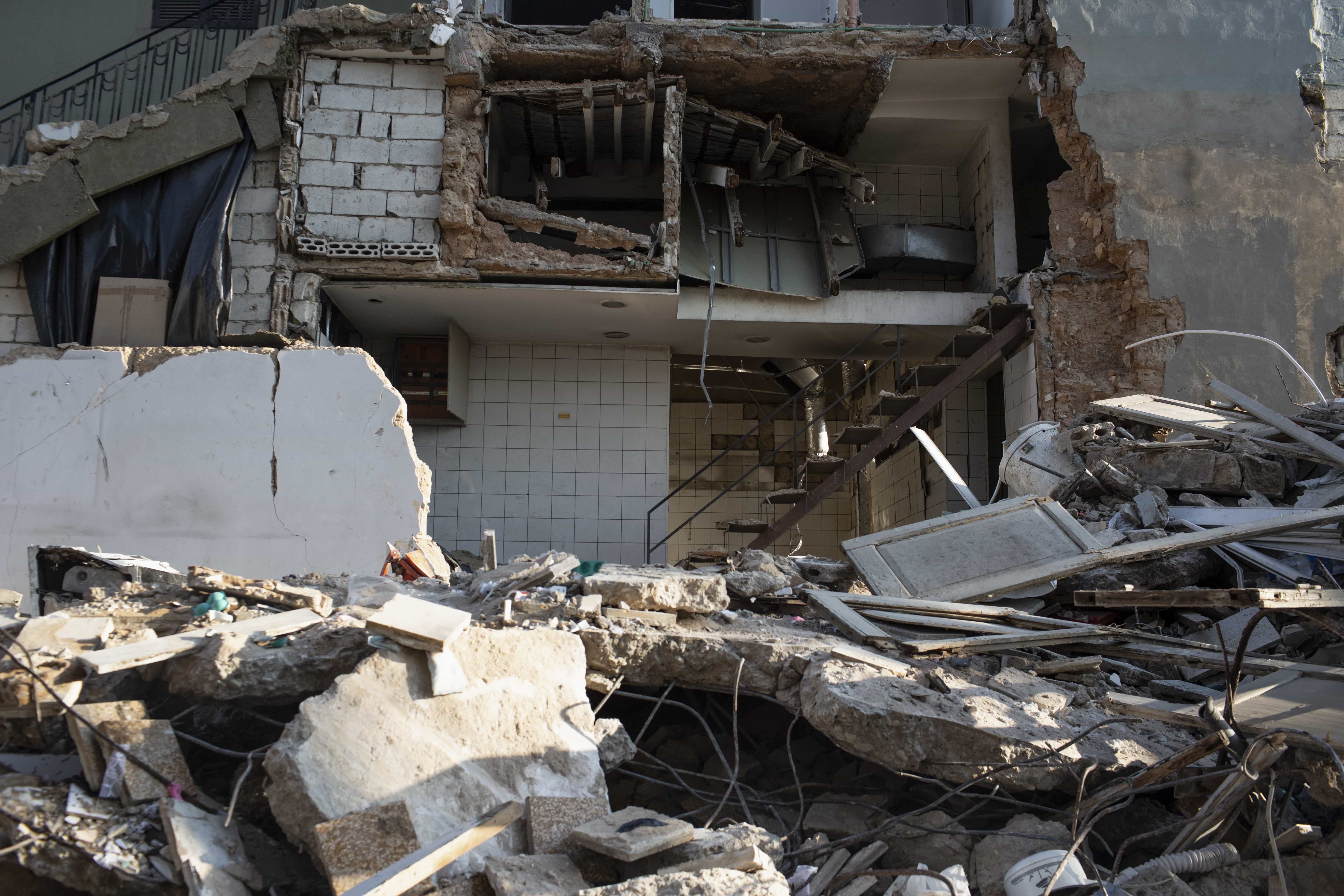 Debris from damaged buildings and roads can be seen over 1,000 feet south of the blast site, a sign of the explosion's force. Many injured people whose homes have been damaged or completely destroyed have been forced to sleep on the street and wait for medical treatment.