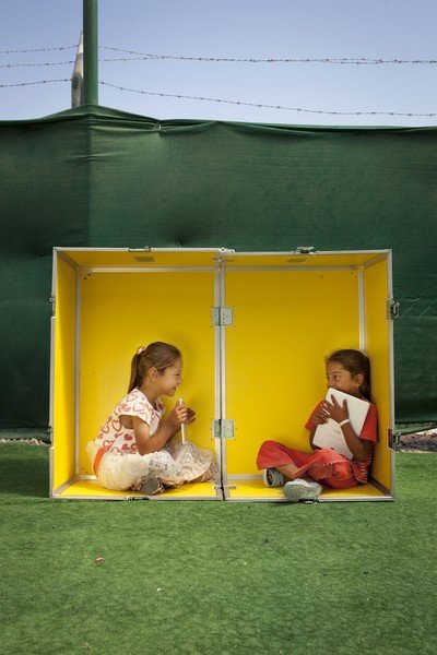 Two children playing inside a yellow box